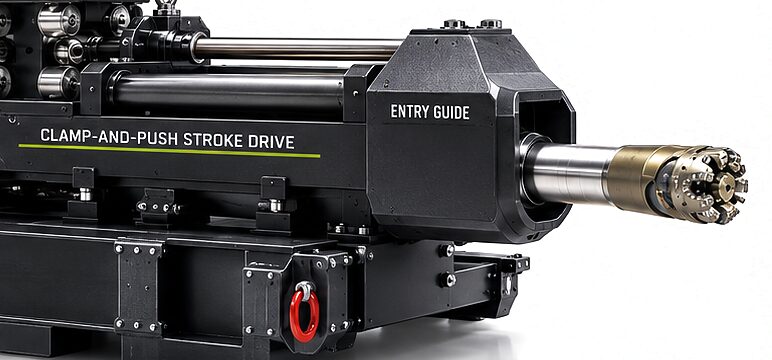 The CS-410 entry guide at the end of the clamp-and-push stroke drive, with the tube standing out of it and the steerable head on the tube.