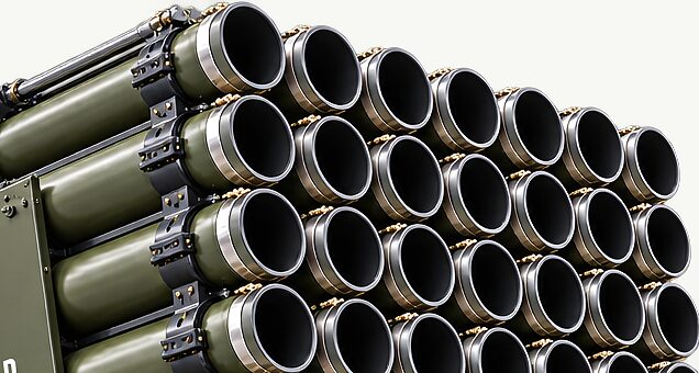 The raised tube array of a launch platform seen end on, rows of open bores held in their clamps against a plain ground.